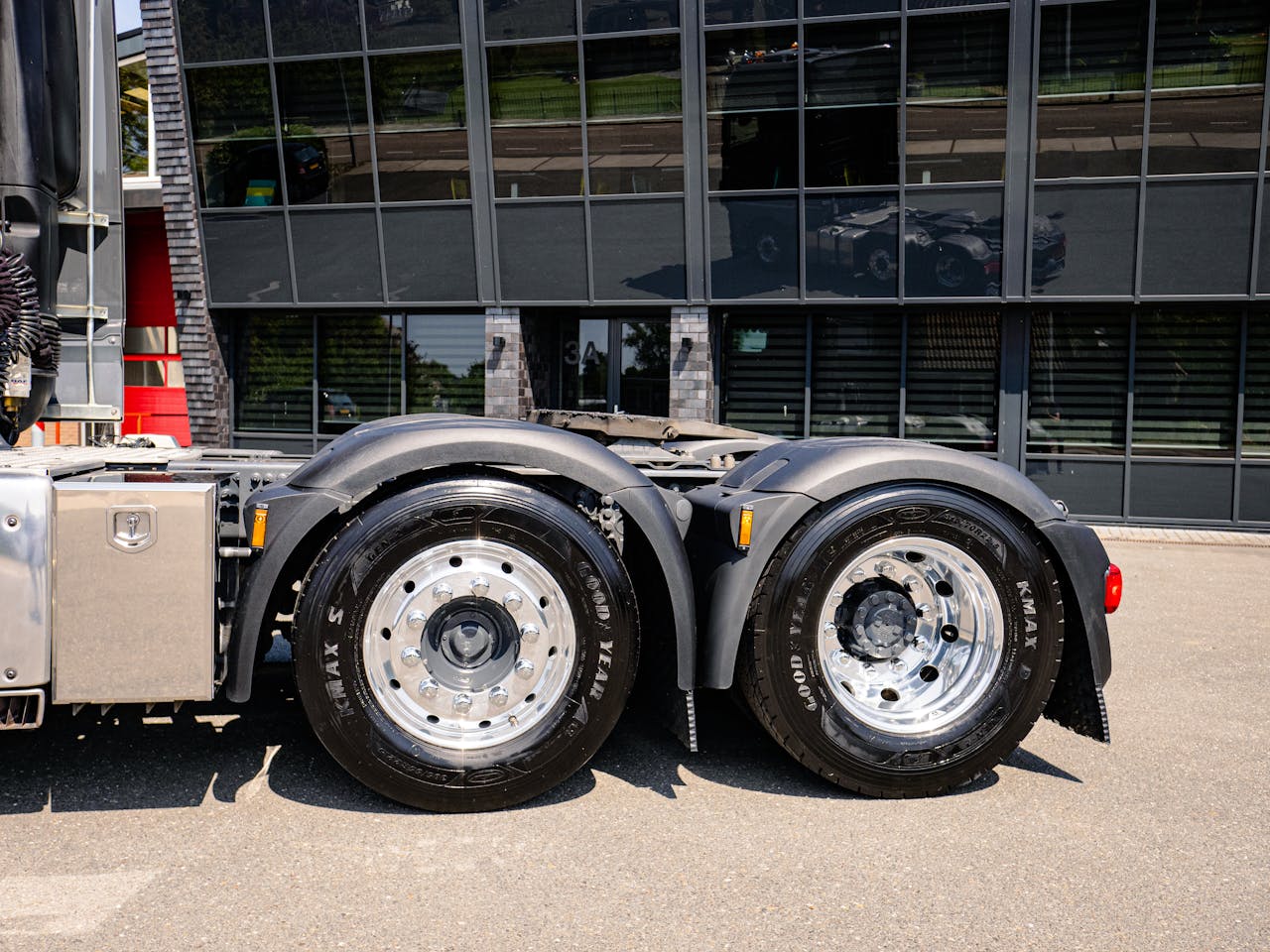 who-we-are Detail of truck wheels with reflective building backdrop in Andijk, Netherlands.